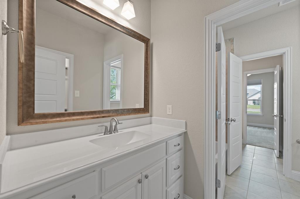 1001 Resolute Road Millsap, TX 76066 - Photo 27 of 40 a bathroom with a sink and a mirror