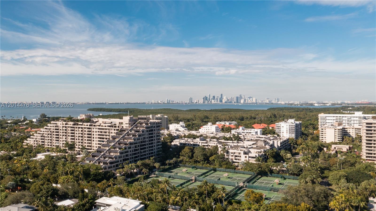 360 Ocean Drive, Unit 1106S Key Biscayne, FL 33149 - Photo 53 of 67 Skyline and Bay View – This elevated view looks across the island toward Biscayne Bay and the distant city skyline. Tennis courts, tropical landscaping, and surrounding residences add depth to the expansive outlook.