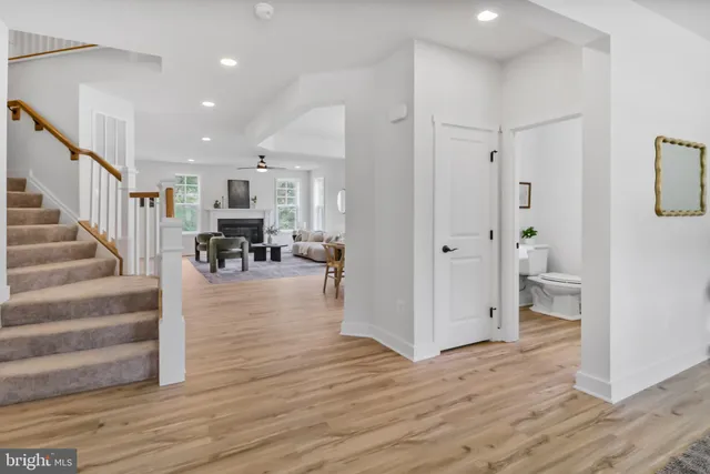 a view of dining room with wooden floor and living room