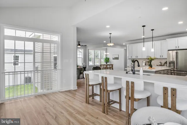 a kitchen with a table chairs refrigerator and microwave