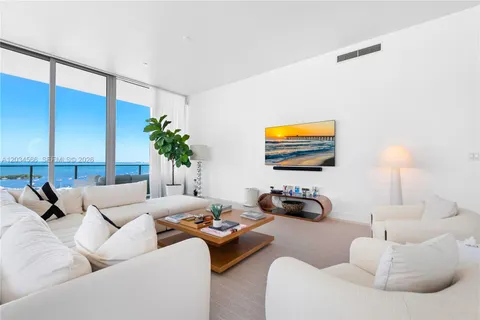 a living room with furniture and a lamp