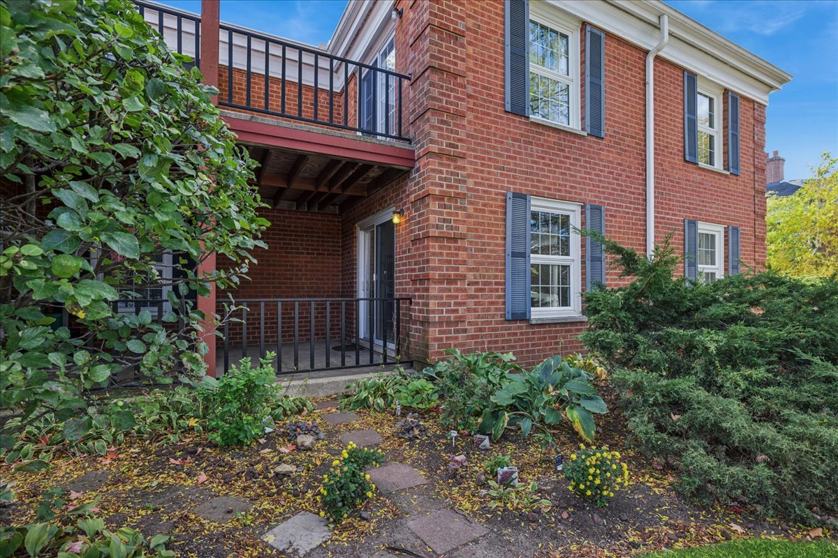 511 Coventry Lane, Unit 2 Crystal Lake, IL 60014 - Photo 19 of 40 a view of a house with brick walls and flower plants
