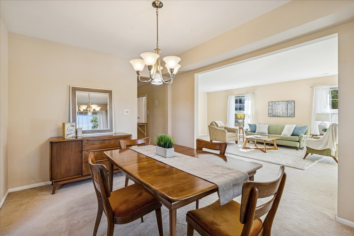 511 Coventry Lane, Unit 2 Crystal Lake, IL 60014 - Photo 9 of 40 a view of a dining room with furniture and a chandelier