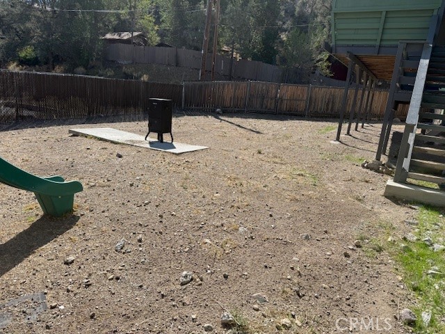 140 Crable Street Frazier Park, CA 93225 - Photo 2 of 16 a wooden bench sitting in the middle of a yard