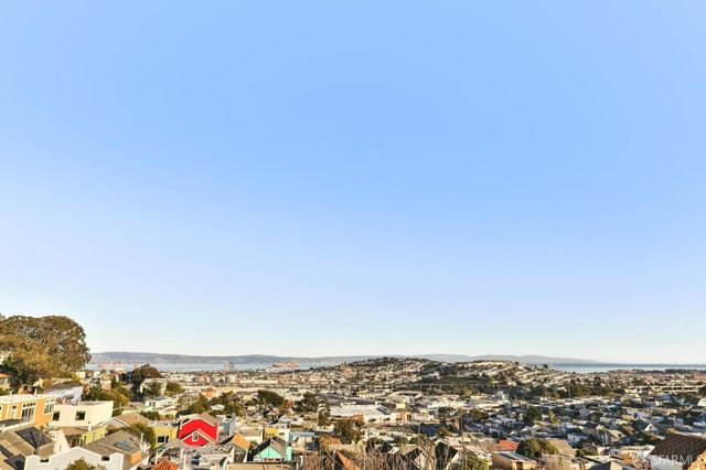 a view of a hallway with a livingroom and a bathroom with sink