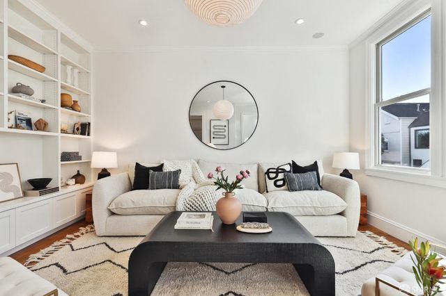 a kitchen with a sink a counter space appliances and cabinets