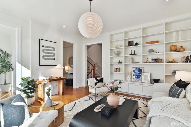 a balcony with wooden floor table and chairs