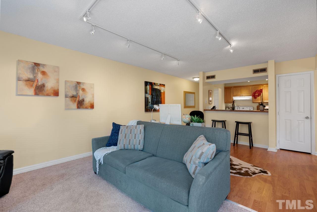 3706 Chimney Ridge Place, Unit 4 Durham, NC 27713 - Photo 13 of 29 a living room with furniture and a flat screen tv