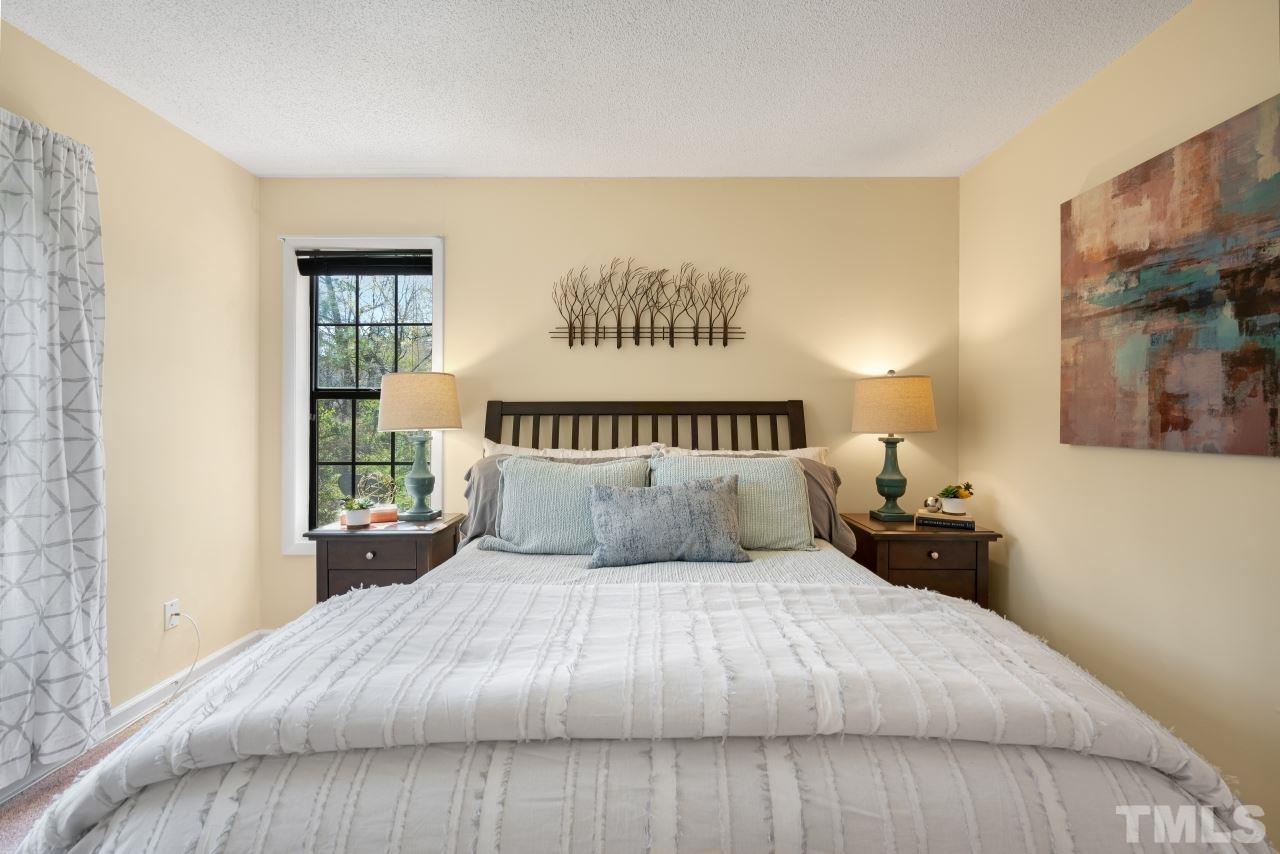 3706 Chimney Ridge Place, Unit 4 Durham, NC 27713 - Photo 17 of 29 a large bed sitting in a bedroom next to a window