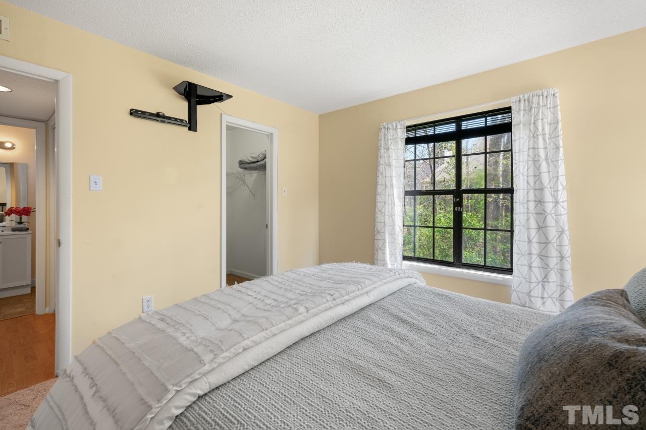3706 Chimney Ridge Place, Unit 4 Durham, NC 27713 - Photo 18 of 29 a view of a bedroom with a bed and a window