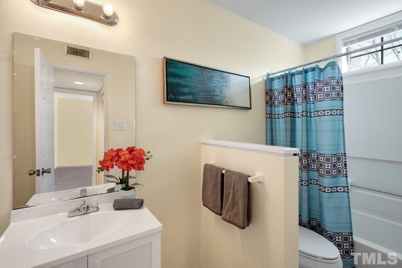 3706 Chimney Ridge Place, Unit 4 Durham, NC 27713 - Photo 19 of 29 a bathroom with a sink mirror and toilet