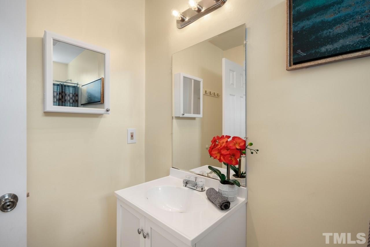 3706 Chimney Ridge Place, Unit 4 Durham, NC 27713 - Photo 20 of 29 a bathroom with a sink mirror and vanity