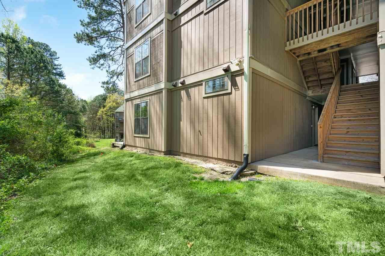 3706 Chimney Ridge Place, Unit 4 Durham, NC 27713 - Photo 26 of 29 a backyard of a house with lots of green space and wooden fence