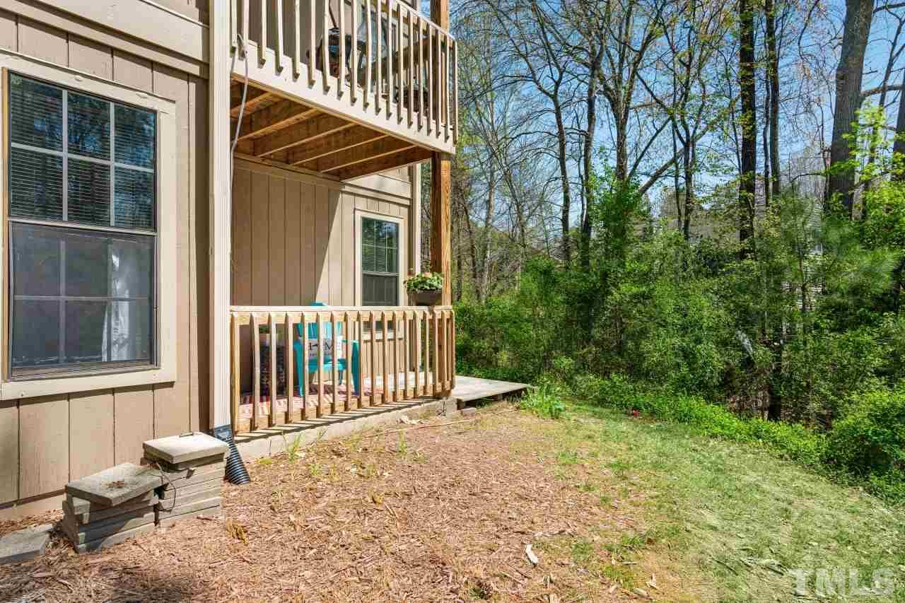 3706 Chimney Ridge Place, Unit 4 Durham, NC 27713 - Photo 27 of 29 a view of a house with a small yard and wooden floor and fence