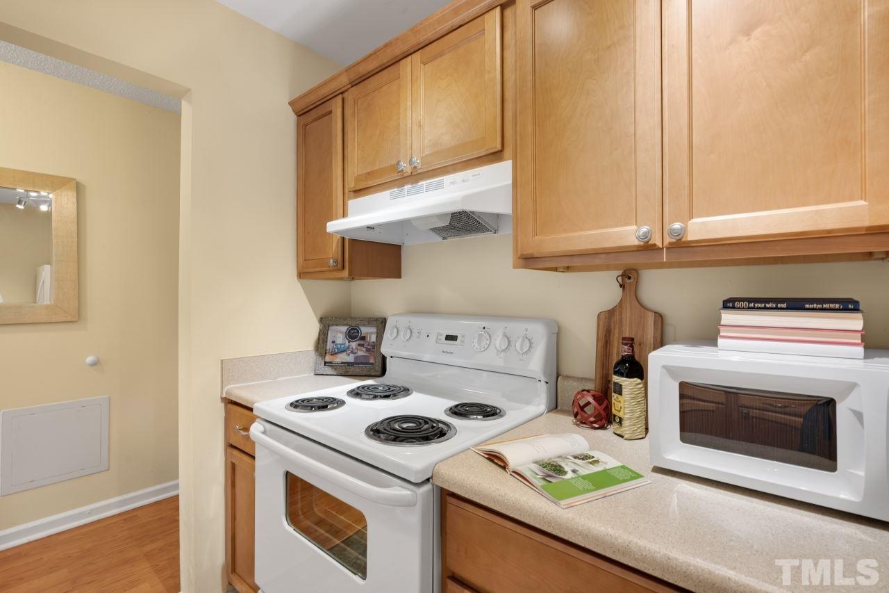 3706 Chimney Ridge Place, Unit 4 Durham, NC 27713 - Photo 5 of 29 a kitchen with a stove a sink and a microwave