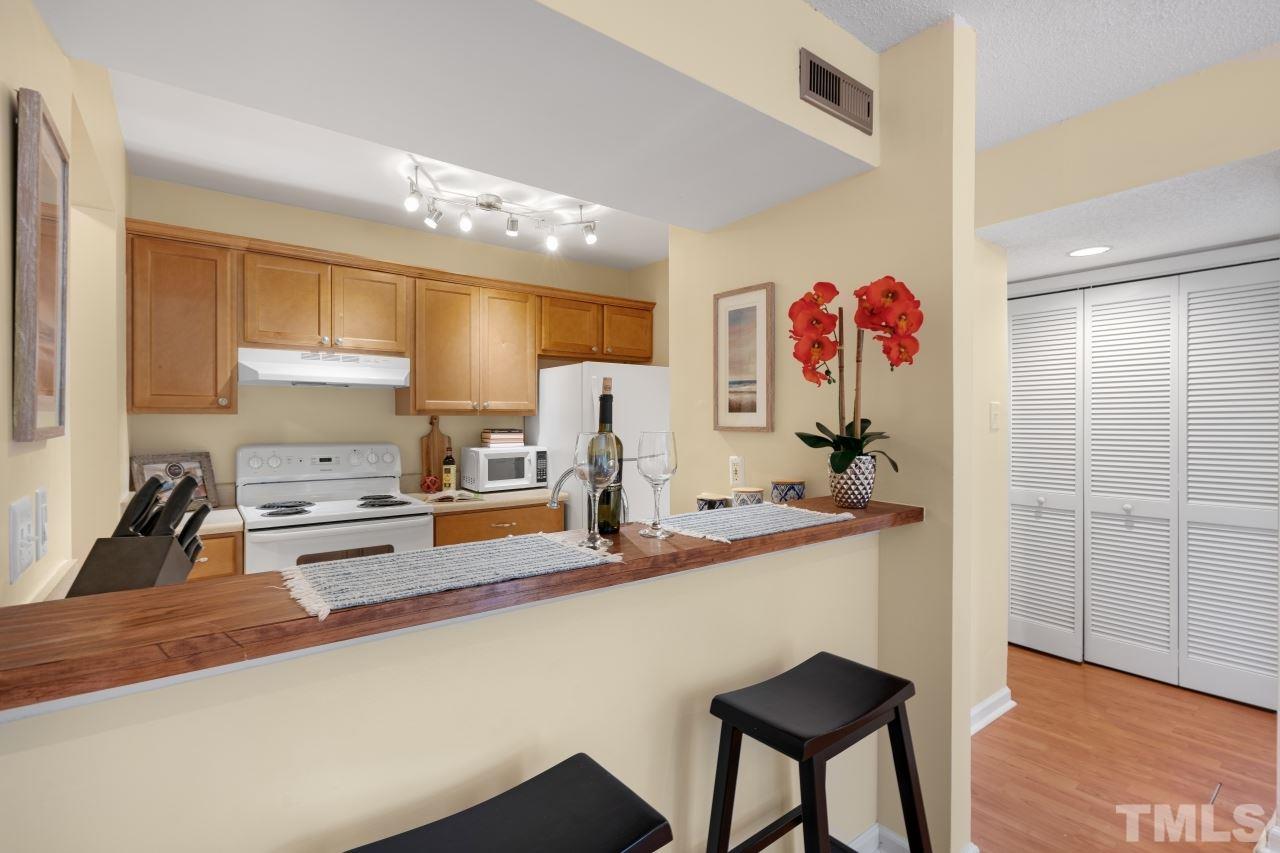 3706 Chimney Ridge Place, Unit 4 Durham, NC 27713 - Photo 8 of 29 a kitchen with a refrigerator and cabinets