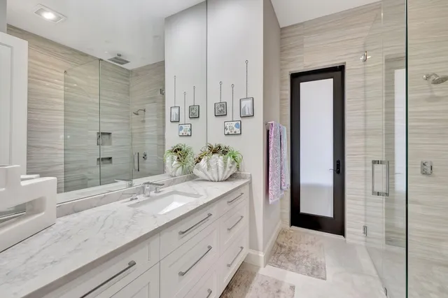 a spacious bedroom with a large bed and a chandelier