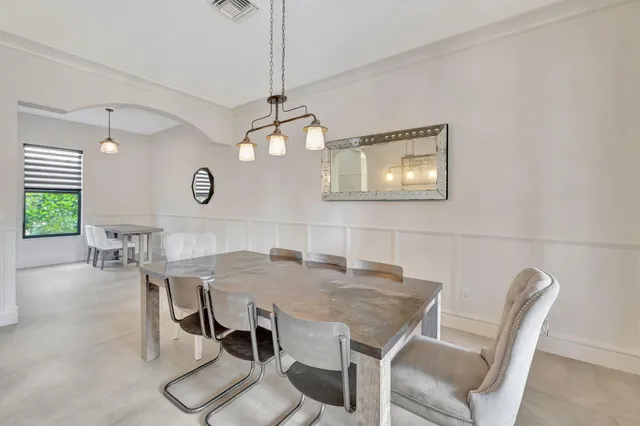 a spacious bedroom with a bed and a flat screen tv