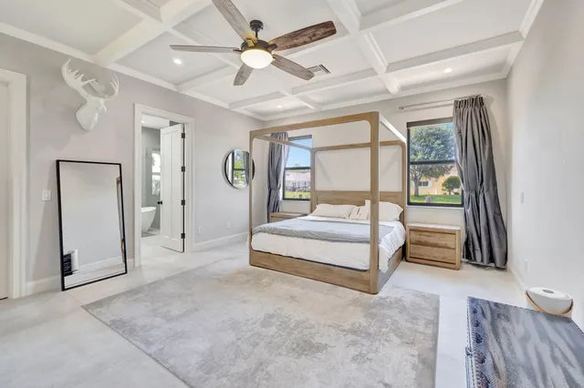 a bathroom with a granite countertop tub a sink and a large mirror