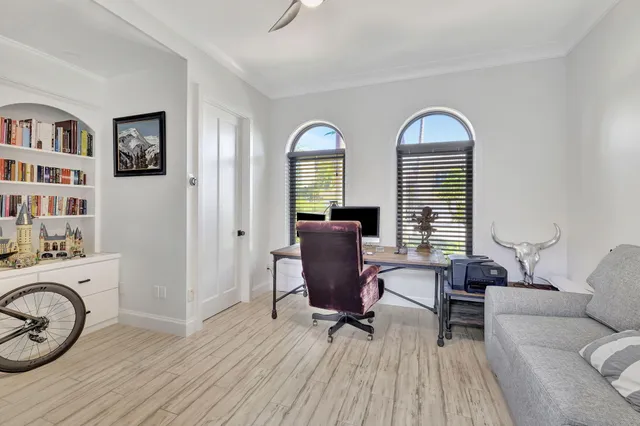 a front view of house with yard and trees in the background