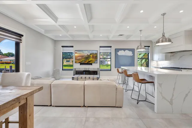 a living room with furniture a flat screen tv and a chandelier