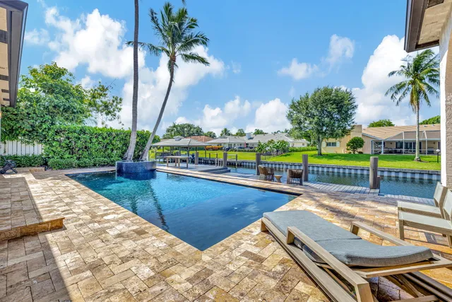 a view of a house with swimming pool and sitting area