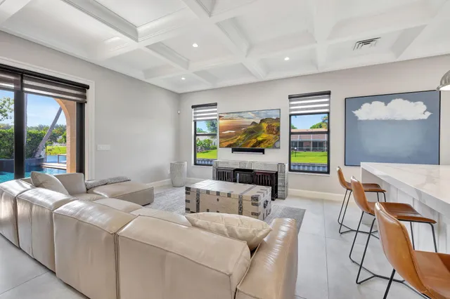 a kitchen with stainless steel appliances kitchen island granite countertop a sink and a refrigerator