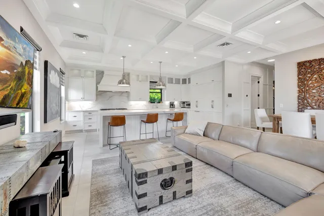 a large kitchen with stainless steel appliances a sink a stove and a wooden floors