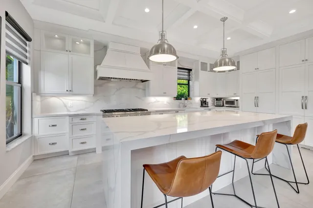 a spacious bathroom with a granite countertop sink a mirror and a shower