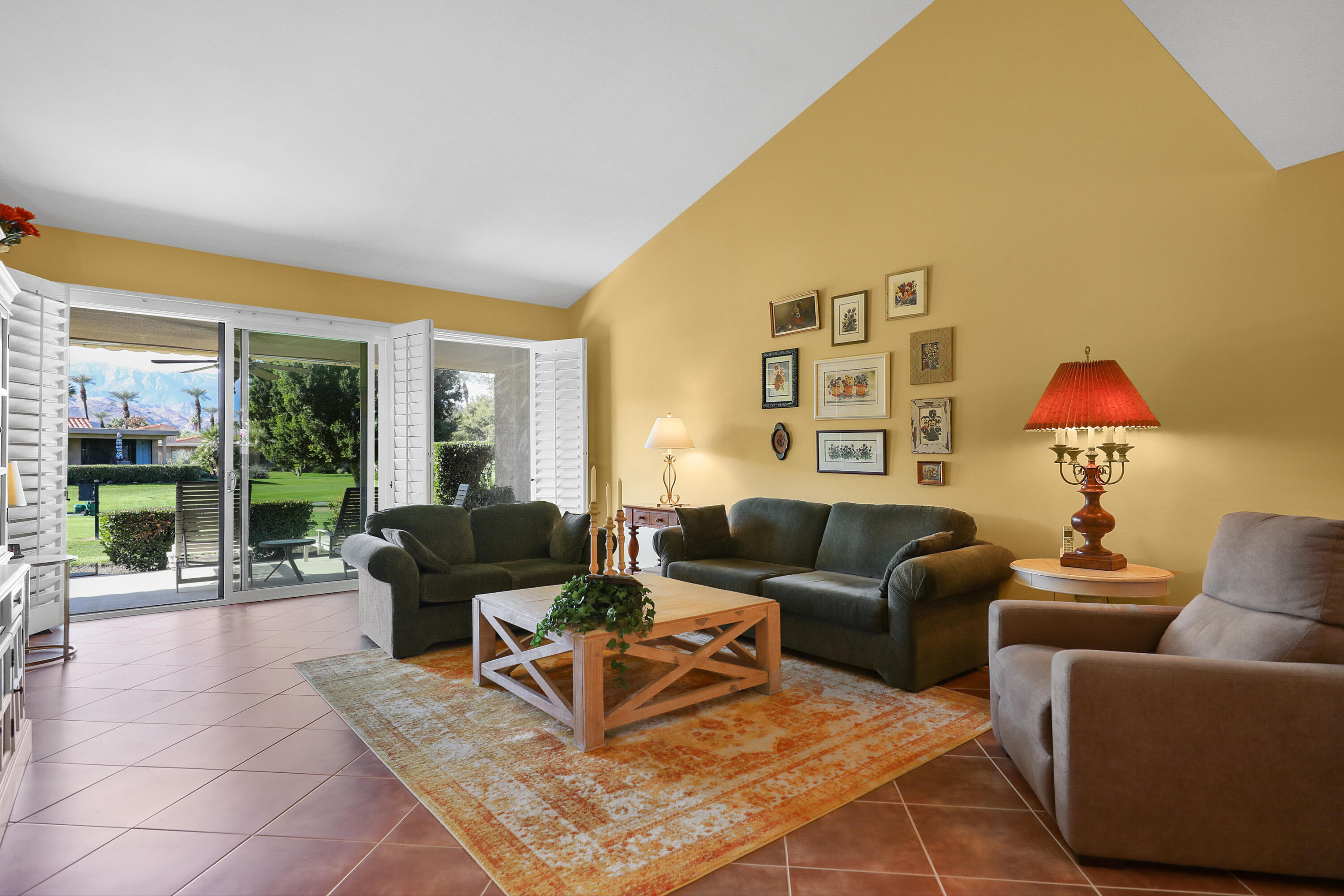 23 La Ronda Drive Rancho Mirage, CA 92270 - Photo 1 of 34 a living room with furniture and a large window