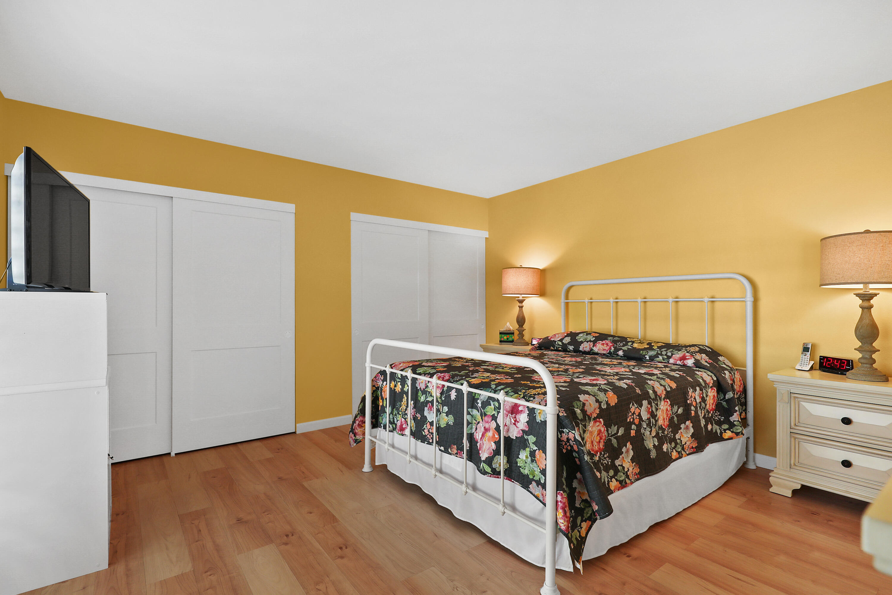 23 La Ronda Drive Rancho Mirage, CA 92270 - Photo 17 of 34 a bedroom with a bed and a night stand