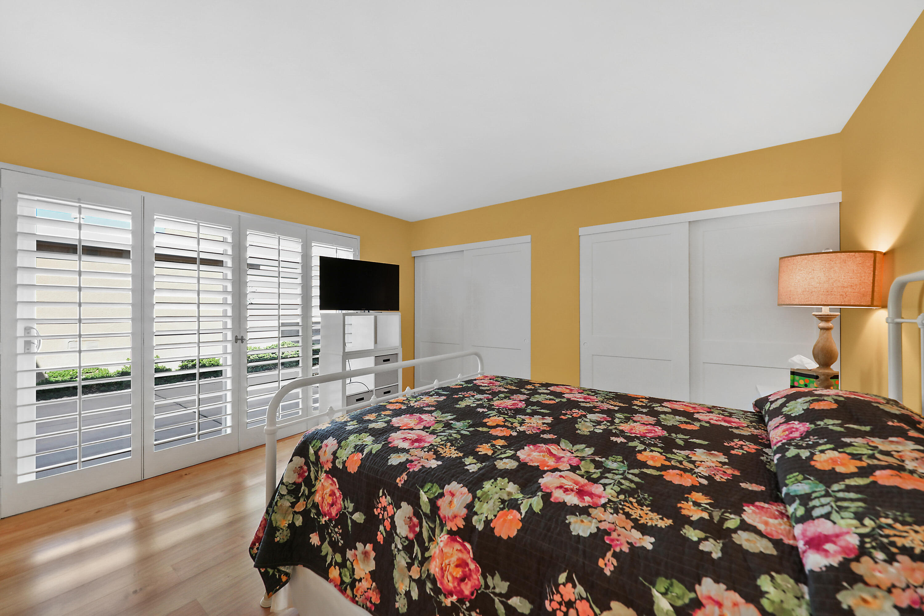 23 La Ronda Drive Rancho Mirage, CA 92270 - Photo 18 of 34 a bedroom with a bed and a flat screen tv