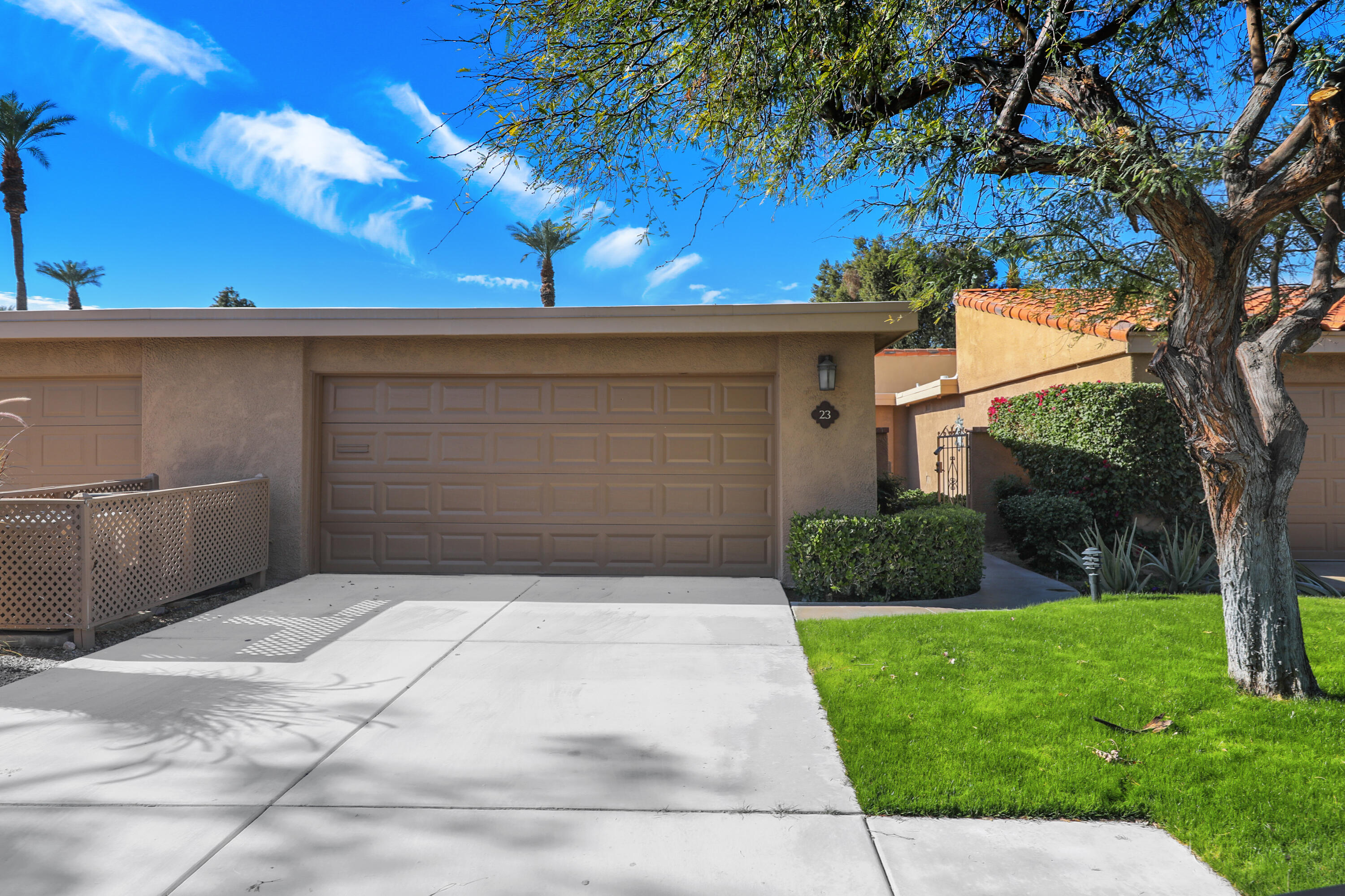 23 La Ronda Drive Rancho Mirage, CA 92270 - Photo 2 of 34 a front view of a house with a yard