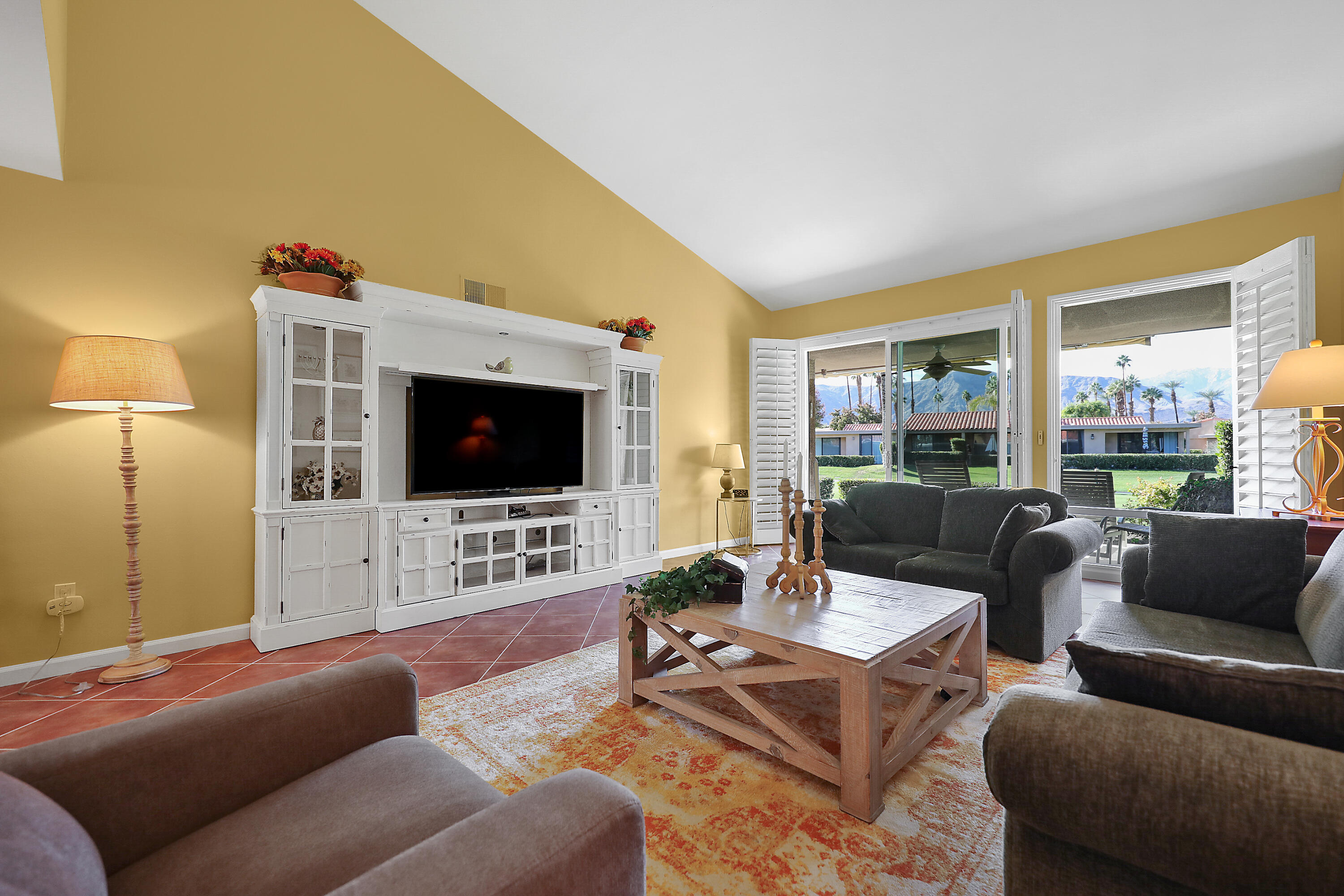 23 La Ronda Drive Rancho Mirage, CA 92270 - Photo 5 of 34 a living room with furniture and a flat screen tv