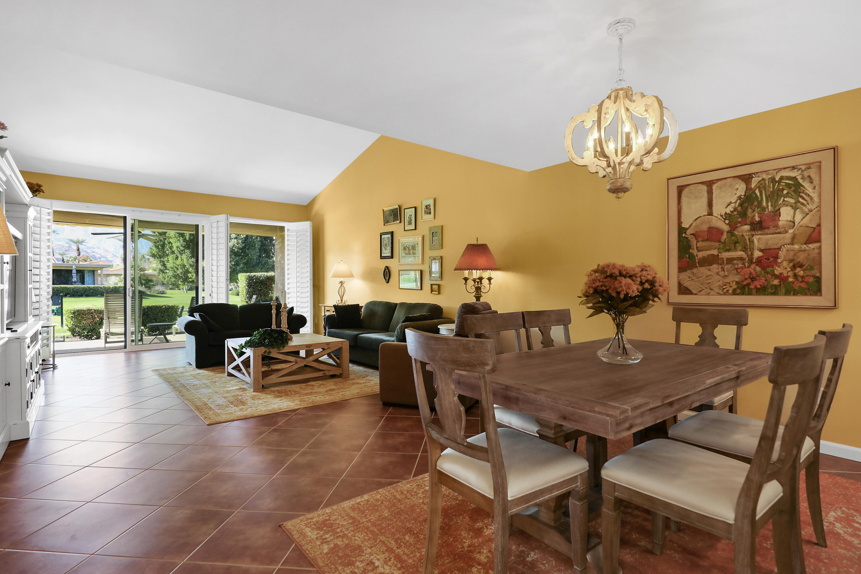 23 La Ronda Drive Rancho Mirage, CA 92270 - Photo 9 of 34 a view of a dining room with furniture a chandelier and wooden floor