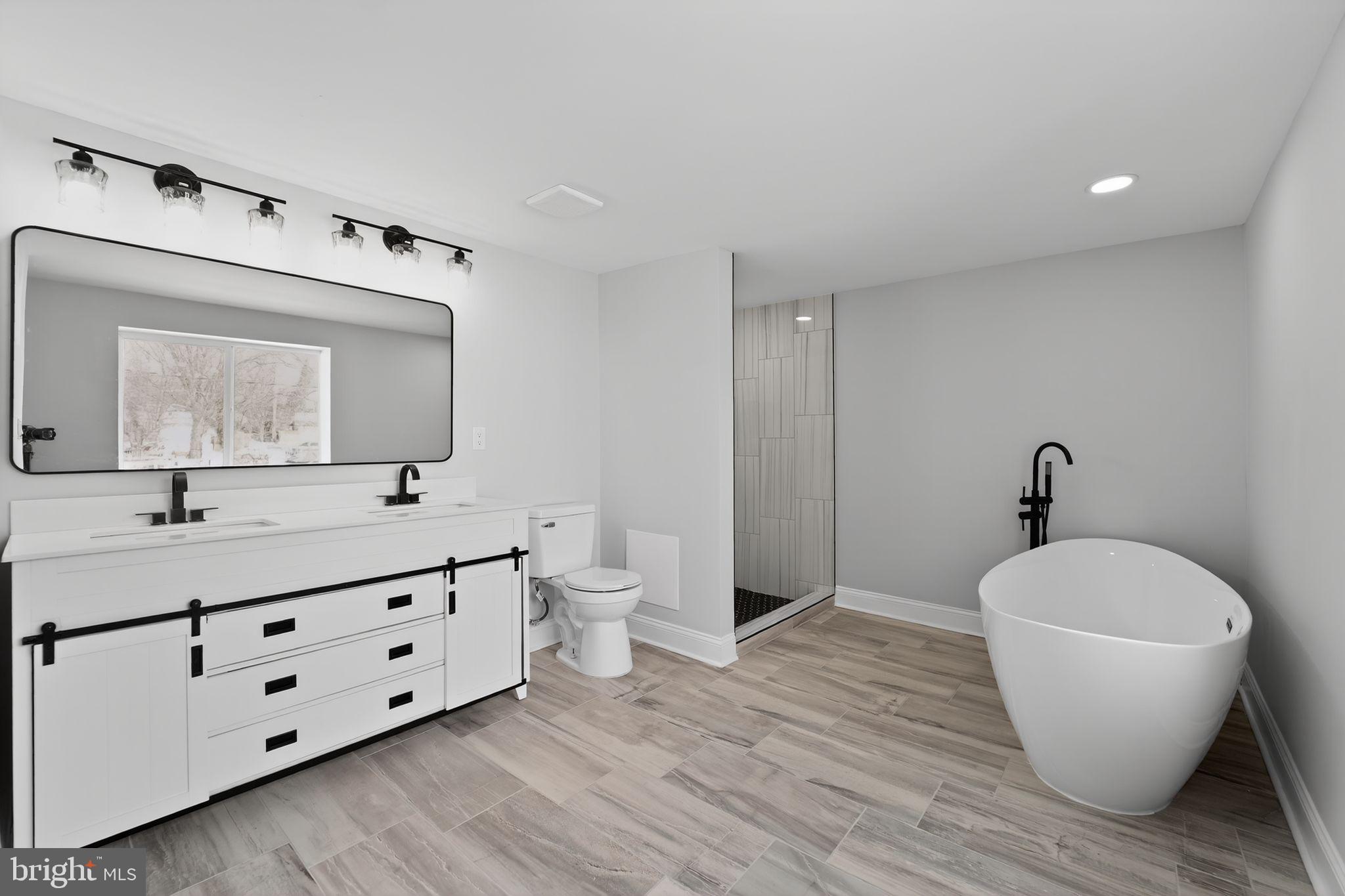 2911 Pinewood Avenue Baltimore, MD 21214 - Photo 14 of 30 a bathroom with a toilet a sink and mirror