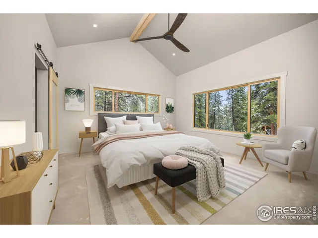 a bedroom with a bed and a large window