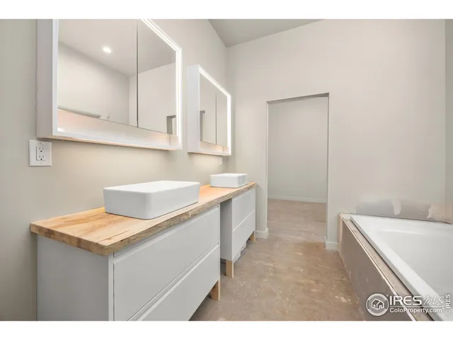 a kitchen with a sink cabinets and wooden floor