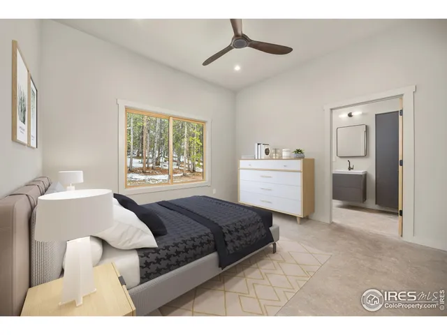 a spacious bedroom with a bed and a window