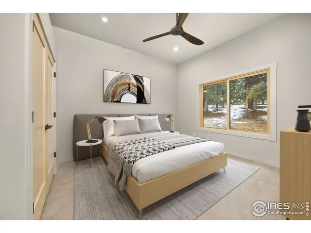 a bedroom with a large bed and a window