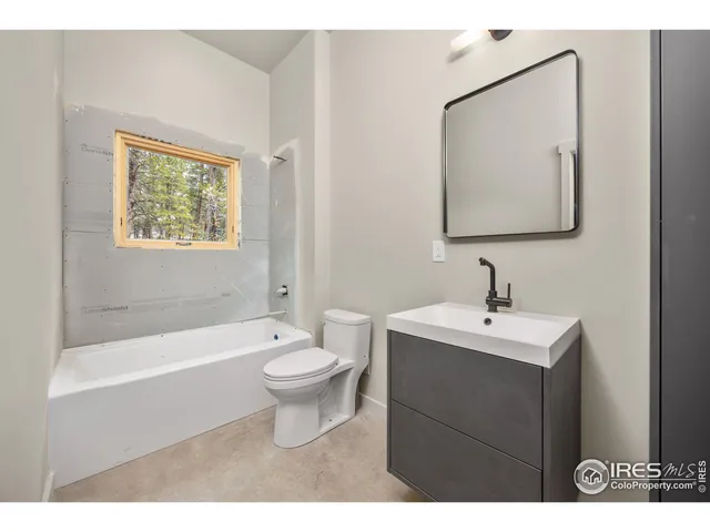 a bathroom with a toilet a sink and bathtub