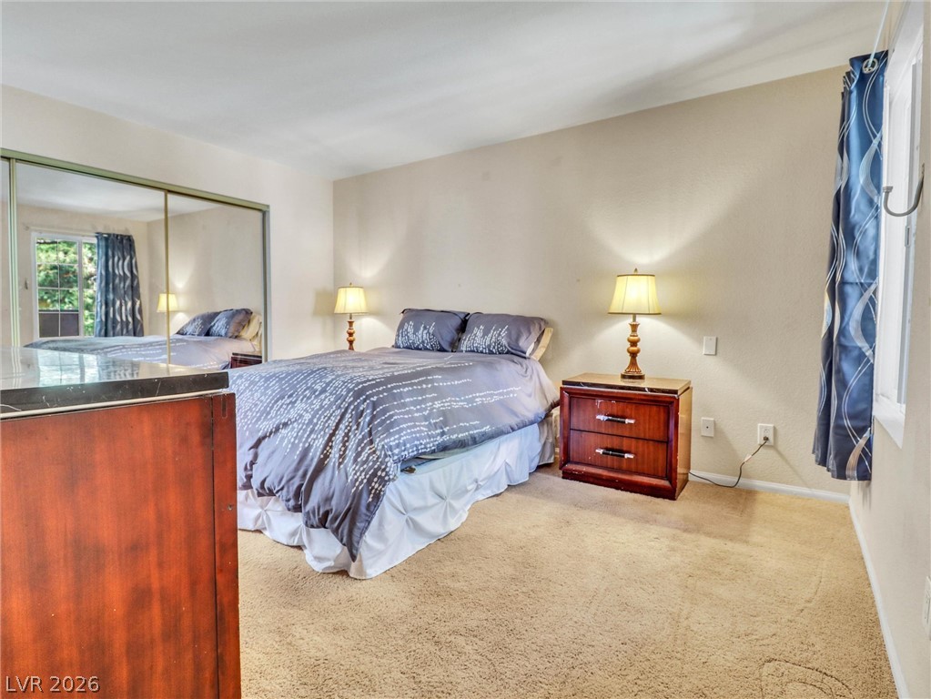 3145 East Flamingo Road, Unit 2129 Las Vegas, NV 89121 - Photo 14 of 43 An inviting sleeping quarter with soft carpet flooring and a mirrored closet offering natural illumination.