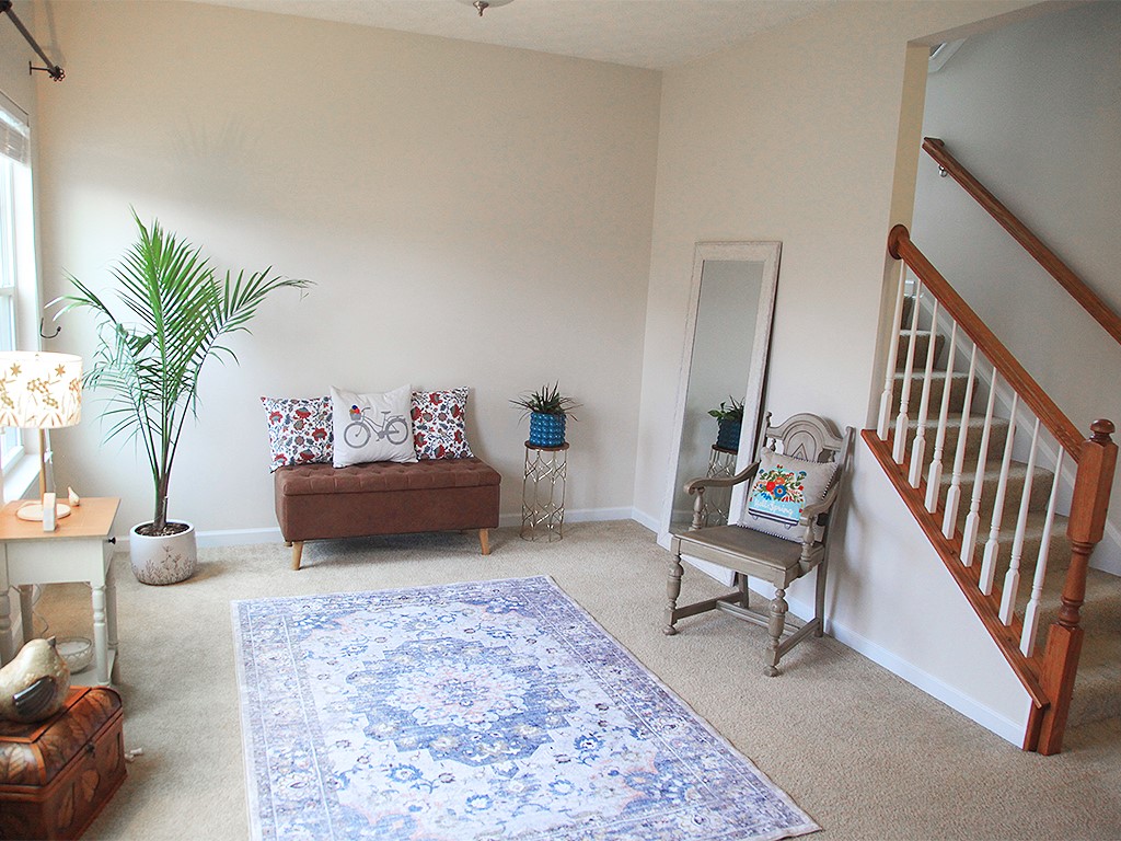 1978 Spring Ridge Drive Xenia, OH 45385 - Photo 5 of 44 This inviting entryway features warm-toned walls, plush carpeting, and a classic wooden staircase.
