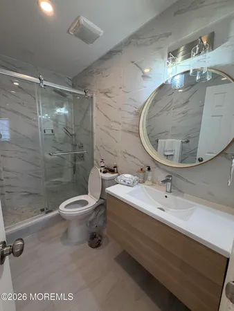 a bathroom with a sink mirror and toilet
