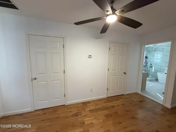 a view of an empty room and closet area
