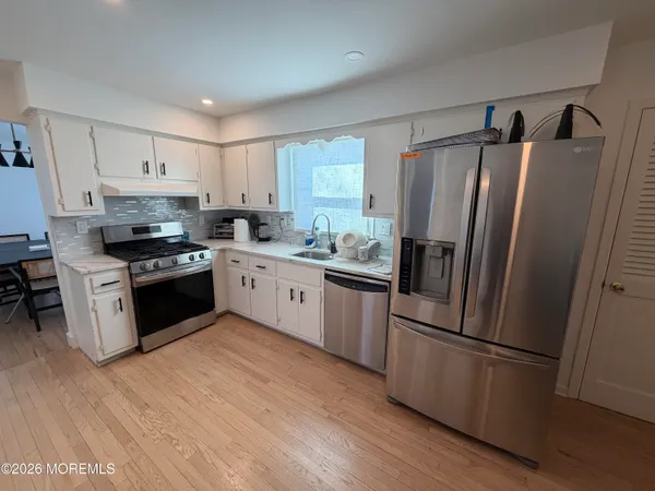 a kitchen with a refrigerator sink and microwave