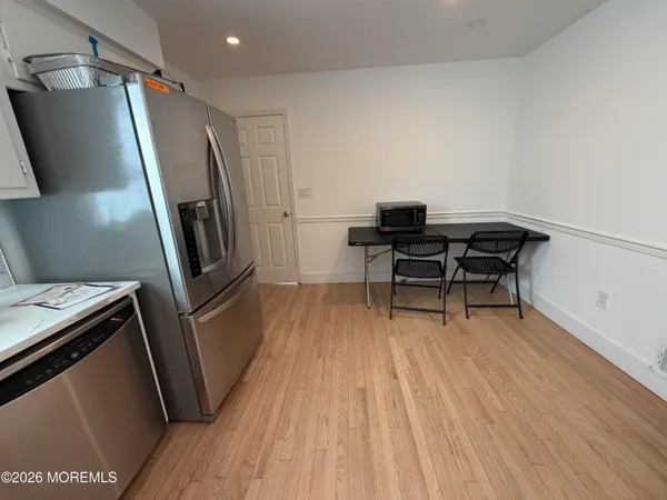 a view of a kitchen with a sink wooden floor and a window