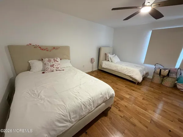 a bedroom with bed and a chandelier