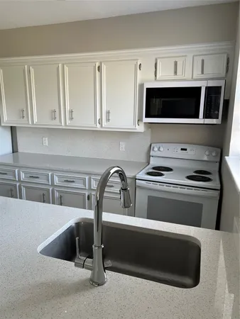 a kitchen with a stove and a microwave