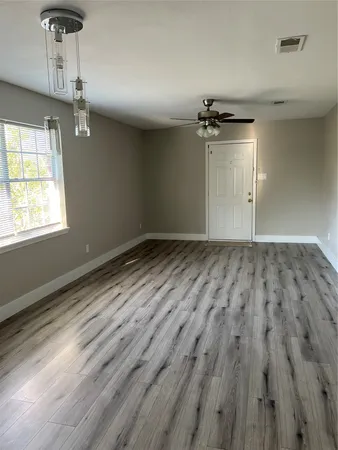 wooden floor in a hall with an empty room